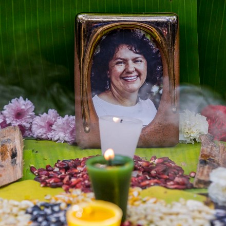 FILE - In this June 15, 2016, file photo, a picture of Berta Caceres sits on an altar in her honor during a demonstration outside Honduras' embassy in Mexico City. Activists demanded justice after the murder of Caceres, a Lenca Indian activist who won the 2015 Goldman Environmental Prize for her role in fighting a dam project. She was shot dead by two men on March 3. Global Witness said Tuesday, July 24, 2018 that at least 207 people who were protecting land and resources from business interests were slain last year. (AP Photo/Eduardo Verdugo)