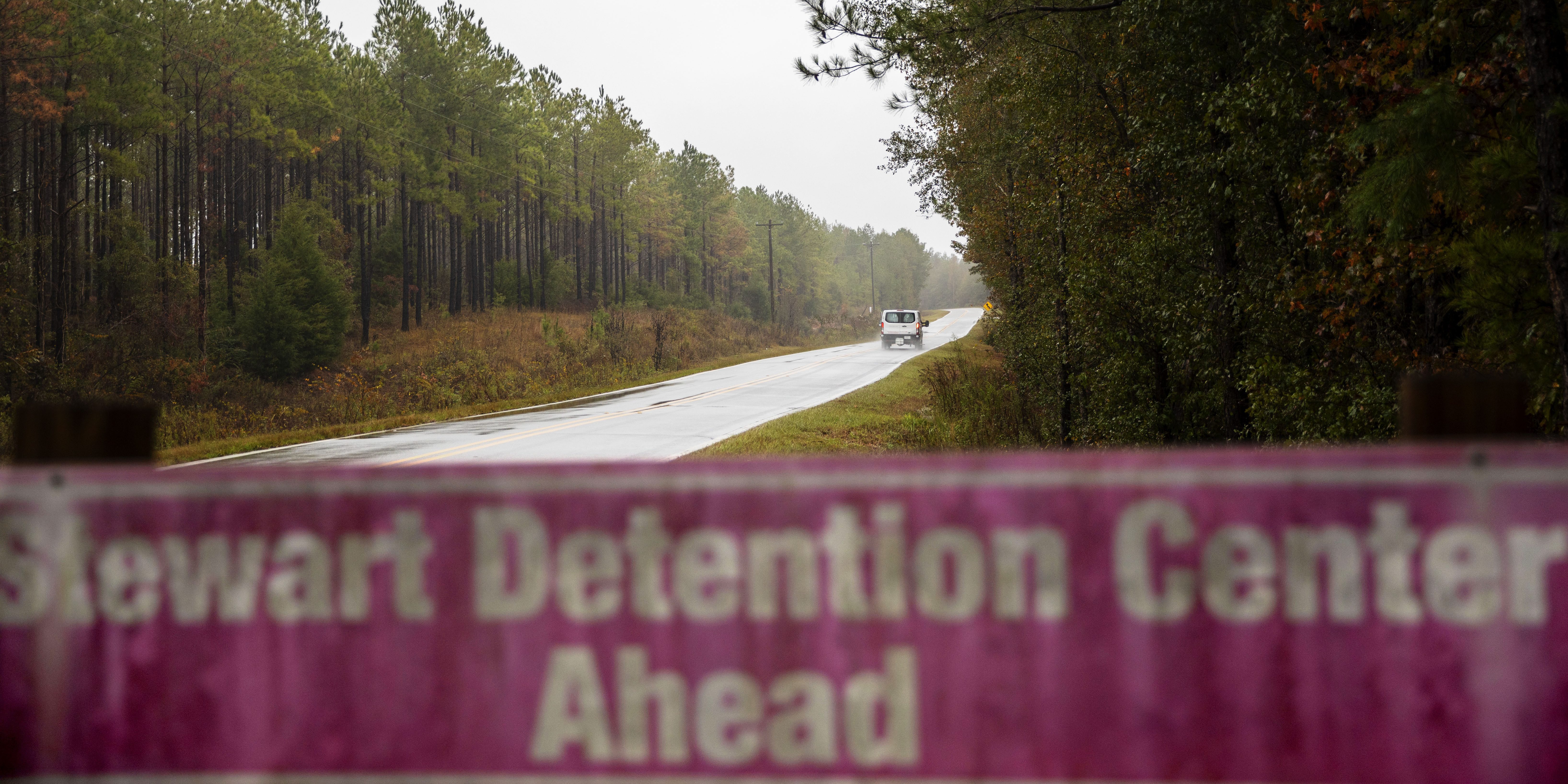 In this Nov. 15, 2019, photo, a detainee transport van travels the rural road back to the Stewart Detention Center in Lumpkin, Ga. The rural town is about 140 miles southwest of Atlanta and next to the Georgia-Alabama state line. The town’s 1,172 residents are outnumbered by the roughly 1,650 male detainees that U.S. Immigration and Customs Enforcement said were being held in the detention center in late November. (AP Photo/David Goldman)