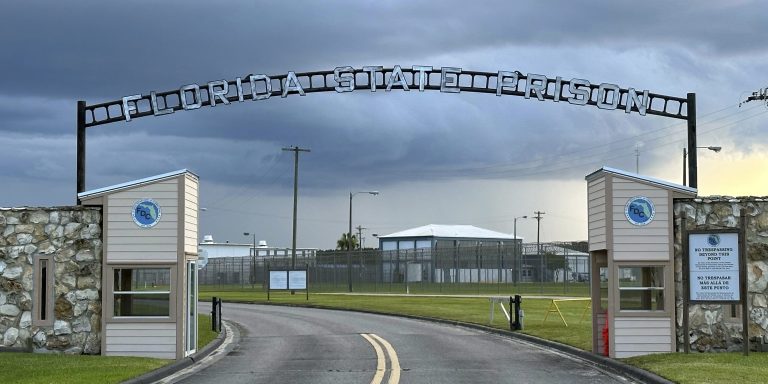 FILE - Clouds hover over the entrance of the Florida State Prison in Starke, Fla., Aug. 3, 2023. (AP Photo/Curt Anderson, File)