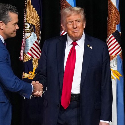 President Donald Trump is greeted by Secretary of Defense Pete Hegseth before speaking to a gathering of top U.S. military commanders at Marine Corps Base Quantico, Tuesday, Sept. 30, 2025, in Quantico, Va.