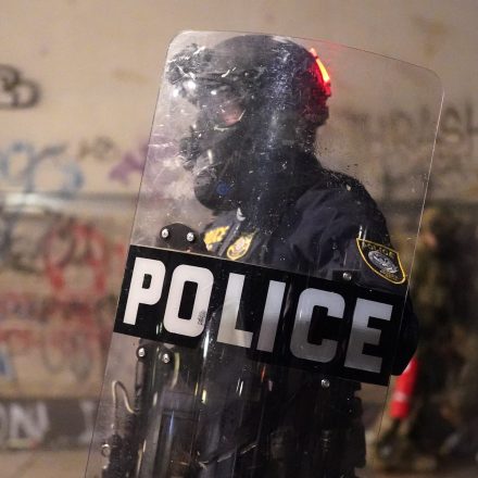 PORTLAND, OR - JULY 24: A federal officer stands guard inside the perimeter fence of the Mark O. Hatfield U.S. Courthouse on Thursday, July 24, 2020 in Portland, Oregon.  Protesters continued to clash with federal officers Friday morning as President Trump announced plans to deploy similar federal forces to other U.S. cities. (Photo by Nathan Howard/Getty Images)