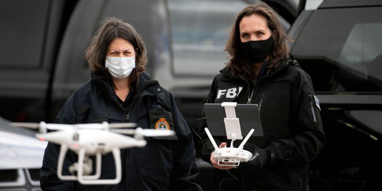 FBI agents prepare to fly a drone at a King Soopers grocery store in Boulder, Colorado on March 23, 2021, one day after a mass shooting left ten dead, including a Boulder police officer. - Colorado police on Tuesday said a 21-year-old man has been charged with 10 counts of murder, a day after a mass shooting at a grocery store in the city of Boulder. "This suspect has been identified as Ahmad Alissa, 21," Boulder Police Chief Maris Herold told a news conference. (Photo by Jason Connolly / AFP) (Photo by JASON CONNOLLY/AFP via Getty Images)
