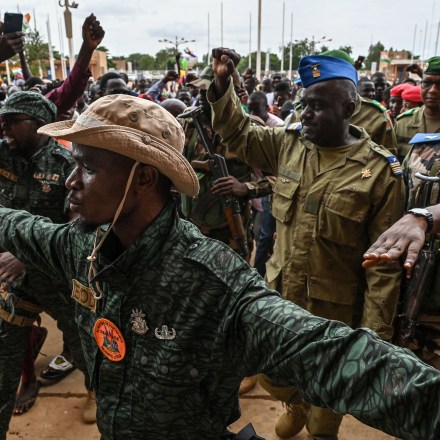 TOPSHOT - Niger's National Council for the Safeguard of the Homeland (CNSP) Colonel-Major Amadou Abdramane (2nd R) is greeted by supporters upon his arrival at the Stade General Seyni Kountche in Niamey on August 6, 2023. Thousands of supporters of the military coup in Niger gathered at a Niamey stadium Sunday, when a deadline set by the West African regional bloc ECOWAS to return the deposed President Mohamed Bazoum to power is set to expire, according to AFP journalists. A delegation of members of the ruling National Council for the Safeguard of the Homeland (CNSP) arrived at the 30,000-seat stadium to cheers from supporters, many of whom were drapped in Russian flags and portraits of CNSP leaders. (Photo by AFP) / "The erroneous mention[s] appearing in the metadata of this photo by - has been modified in AFP systems in the following manner: [Colonel-Major Amadou Abdramane] instead of [Colonel-Major Amadou Adramane]. Please immediately remove the erroneous mention[s] from all your online services and delete it (them) from your servers. If you have been authorized by AFP to distribute it (them) to third parties, please ensure that the same actions are carried out by them. Failure to promptly comply with these instructions will entail liability on your part for any continued or post notification usage. Therefore we thank you very much for all your attention and prompt action. We are sorry for the inconvenience this notification may cause and remain at your disposal for any further information you may require." (Photo by -/AFP via Getty Images)