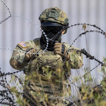 A Texas National Guard soldier puts up additional razor wire at the U.S.-Mexico border in El Paso, Texas on January 31, 2024.