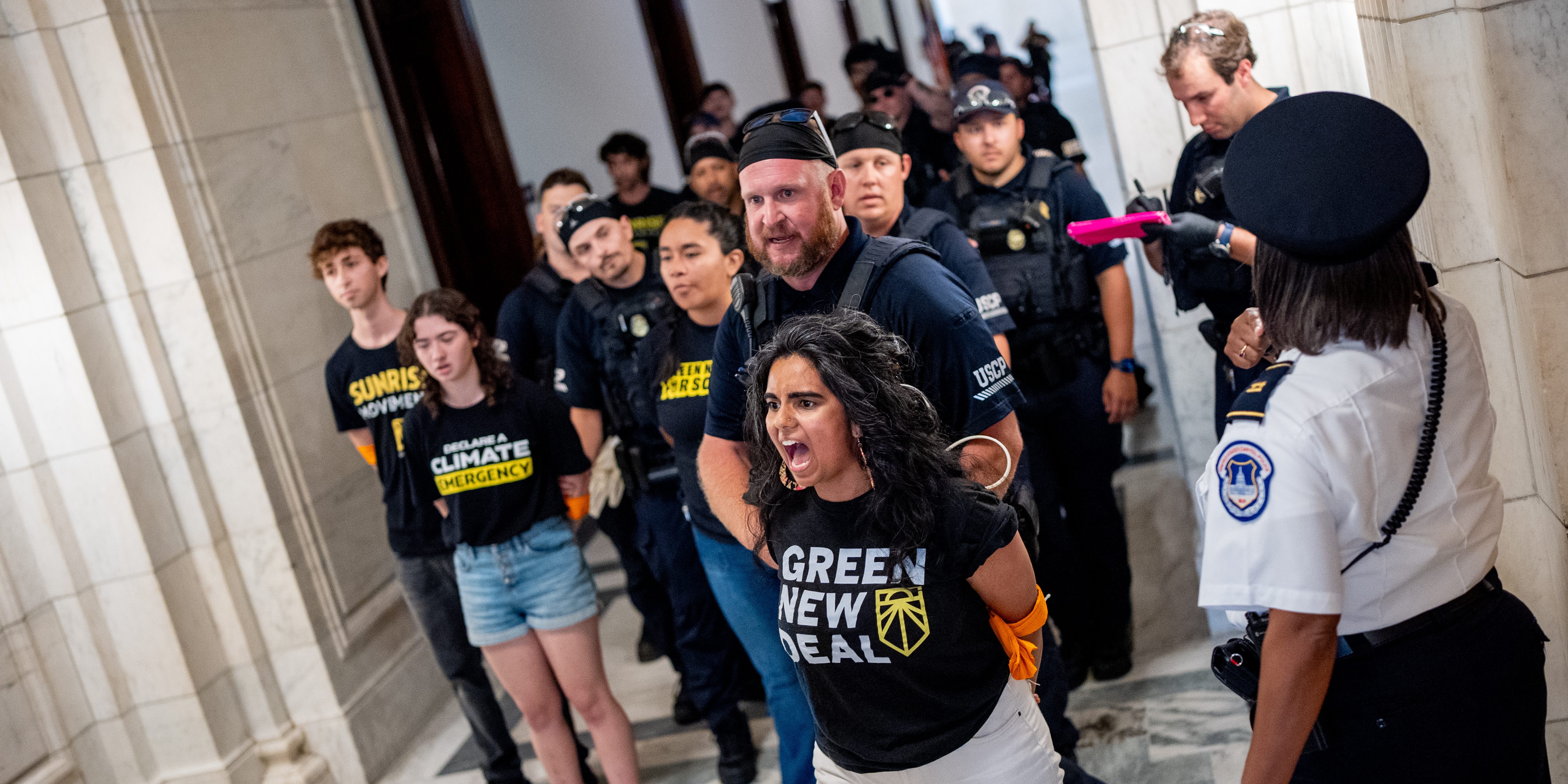 WASHINGTON, DC - JULY 29: Members of the Sunrise Movement are arrested as they protest outside the Senate office of Republican vice presidential nominee, U.S. Sen. J.D. Vance (R-OH) on Capitol Hill on July 29, 2024 in Washington, DC. The Sunrise Movement, a climate change political action group, held signs accusing Vance of being in the pocket of big oil companies. (Photo by Andrew Harnik/Getty Images)