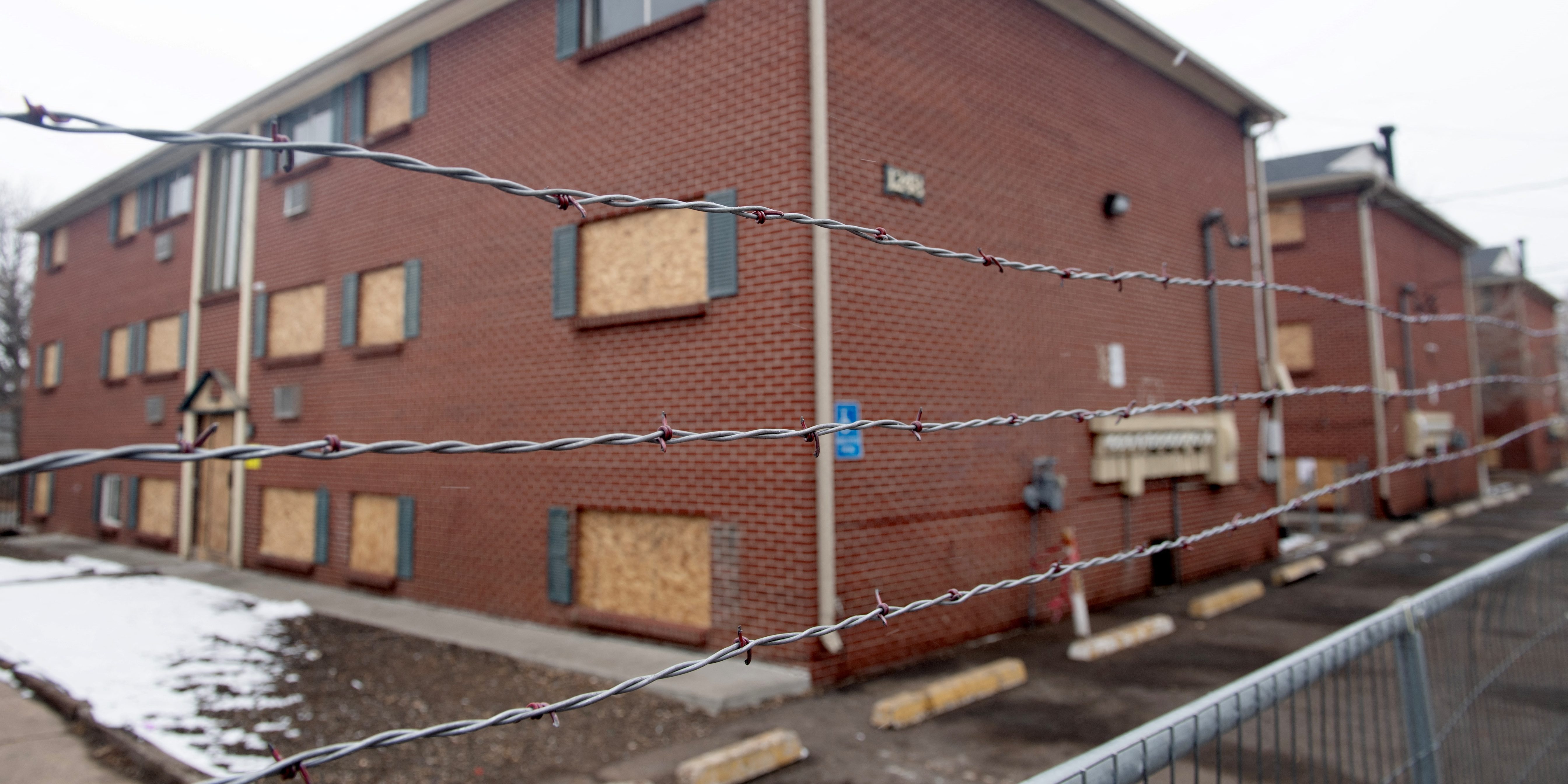 Barbed wire is strung across a chain link fence at the Edge at Lowry apartment complex in Aurora, Colorado, on February 17, 2025.