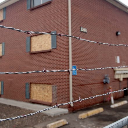 Barbed wire is strung across a chain link fence at the Edge at Lowry apartment complex in Aurora, Colorado, on February 17, 2025.