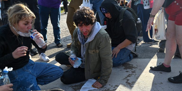BROADVIEW, ILLINOIS - SEPTEMBER 19: Demonstrators protesting outside the U.S Immigration & Customs Enforcement facility, including Democratic congressional candidate Kat Abughazaleh, 26, left, react after being tear-gassed on September 19, 2025 in Broadview, Illinois. Protesters were speaking out against recent ICE raids and arrest taking place in Chicago and surrounding suburbs. President Donald Trump has deployed ICE Agents and other federal agencies to Chicago to enforce immigration laws. Trump is also threatening to send the National Guard to fight crime in the city. (Photo by Joshua Lott/The Washington Post via Getty Images).