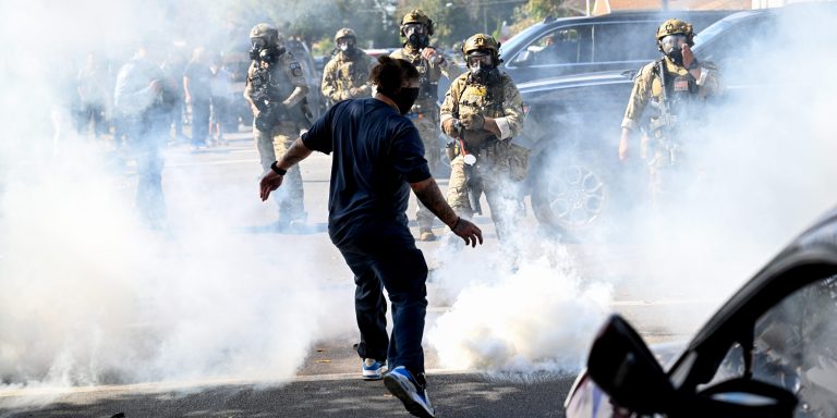 CHICAGO, ILLINOIS - OCTOBER 14:  Residents and protesters clash with federal agents in the East Side neighborhood after tear gas was detonated on October 14, 2025 in Chicago, Illinois. It was not immediately clear why federal agents were in the area but people on social media reported Immigration and Customs Enforcement agents arrested an individual and caused a car accident. Last week a Federal judge put in place a temporary order preventing the 500 National Guard troops that were sent to the Chicago and surrounding suburbs to help protect ICE and other federal agents and federal property. President Donald Trumps's administration continues to enforce immigration laws in Chicago and the surrounding suburbs during their "Operation Midway Blitz."  (Photo by Joshua Lott/The Washington Post via Getty Images)