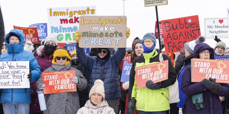 MINNEAPOLIS, USA - DECEMBER 4: Community members hold banners as they show up to a press conference to demand accountability from Target after ICE agents were spotted staging at the parking lot in Minneapolis, USA on December 4, 2025. (Photo by Christopher Juhn/Anadolu via Getty Images)