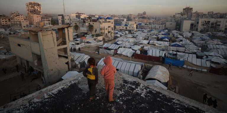 GAZA CITY, GAZA - DECEMBER 22: Many displaced Palestinians struggle to maintain their daily lives under harsh conditions amid the rubble left by Israeli attacks in Gaza City, Gaza on December 22, 2025. Lacking basic necessities, families cling to life in makeshift tents set up near their destroyed homes while battling cold weather conditions. (Photo by Khames Alrefi/Anadolu via Getty Images)