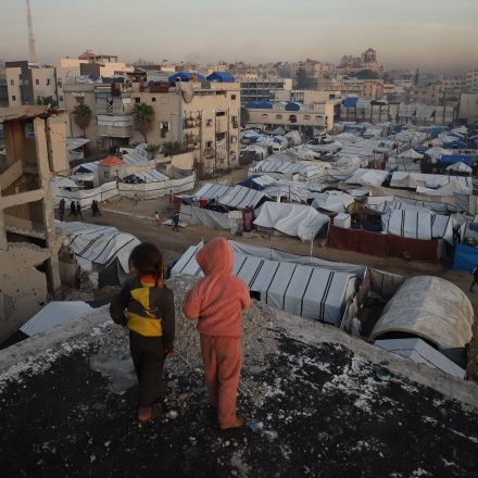GAZA CITY, GAZA - DECEMBER 22: Many displaced Palestinians struggle to maintain their daily lives under harsh conditions amid the rubble left by Israeli attacks in Gaza City, Gaza on December 22, 2025. Lacking basic necessities, families cling to life in makeshift tents set up near their destroyed homes while battling cold weather conditions. (Photo by Khames Alrefi/Anadolu via Getty Images)